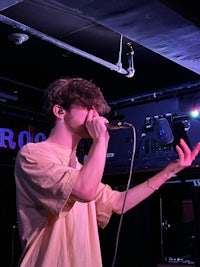 a man singing into a microphone at a concert