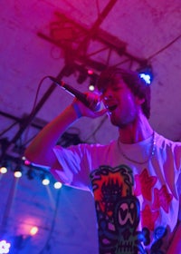 a man singing into a microphone at a concert