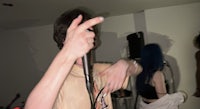 a person holding a microphone in front of a group of people