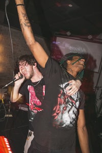two men on stage with microphones in their hands