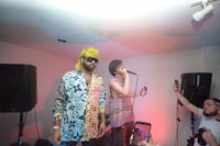 two men standing in front of a microphone