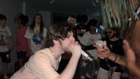 a man is holding a microphone in front of a crowd of people